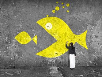 Big fish swallowing a little one, representing a business acquisition